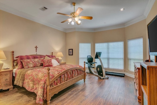 bedroom with ceiling fan, crown molding, and hardwood / wood-style floors