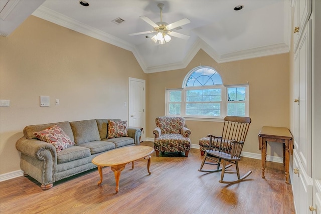 living room with light hardwood / wood-style floors, ceiling fan, vaulted ceiling, and ornamental molding