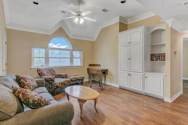 living room featuring crown molding, ceiling fan, and light wood-type flooring