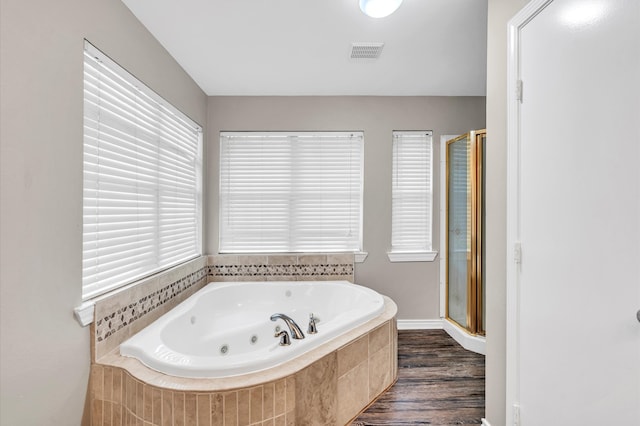 bathroom featuring shower with separate bathtub and hardwood / wood-style floors