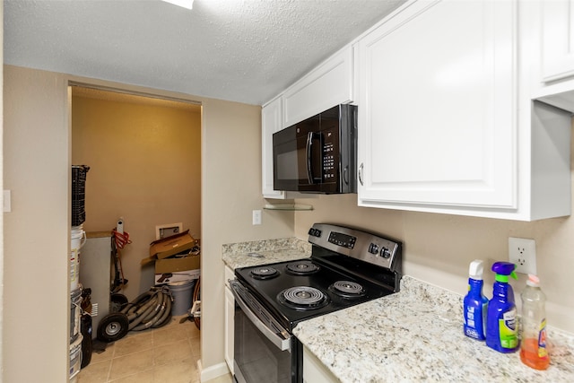 kitchen with stainless steel electric stove, white cabinetry, light tile floors, and a textured ceiling