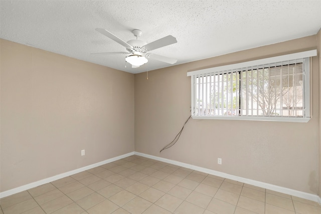 tiled spare room featuring ceiling fan and a textured ceiling