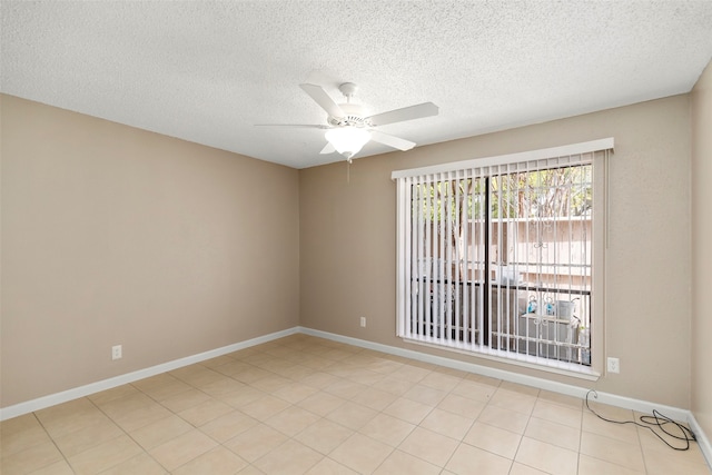 tiled empty room with a textured ceiling and ceiling fan