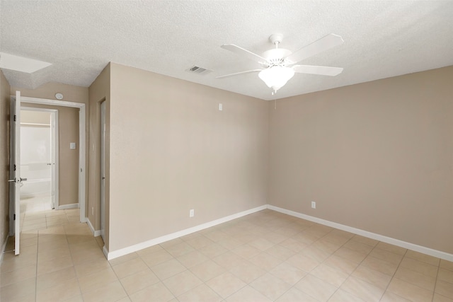 unfurnished room featuring light tile floors, a textured ceiling, and ceiling fan