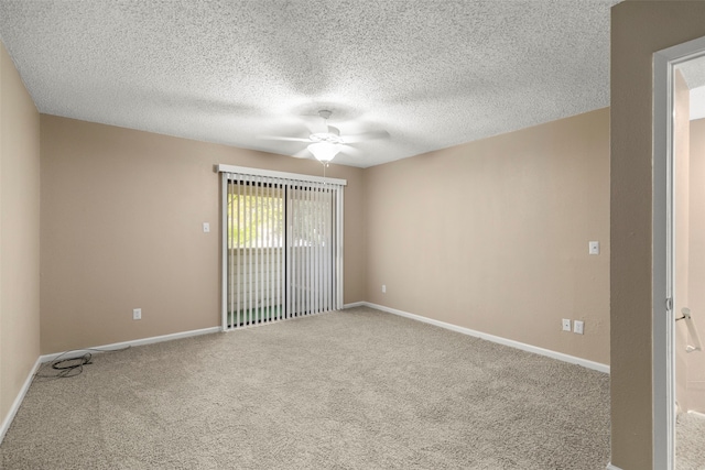 carpeted spare room featuring a textured ceiling and ceiling fan