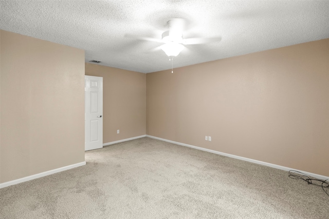 unfurnished room featuring ceiling fan, light carpet, and a textured ceiling