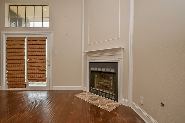 unfurnished living room with dark hardwood / wood-style flooring