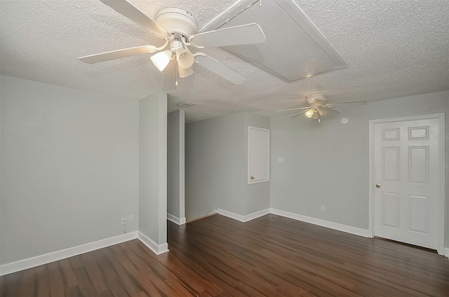 unfurnished room with a textured ceiling, ceiling fan, and dark hardwood / wood-style flooring