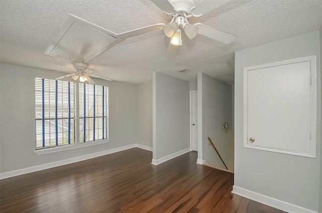 spare room featuring a textured ceiling, dark hardwood / wood-style floors, and ceiling fan