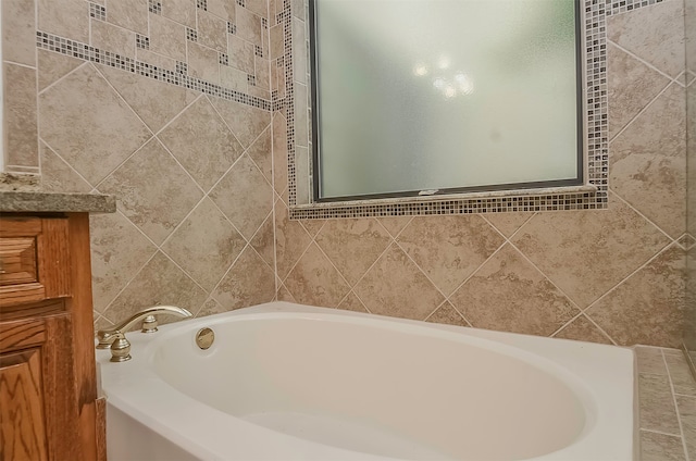 bathroom with tiled bath and tile walls