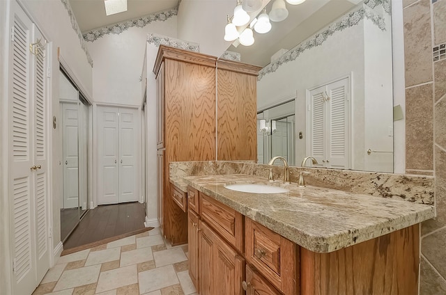 bathroom featuring large vanity and tile flooring