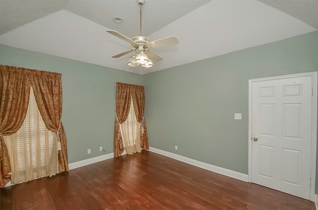 unfurnished room featuring ceiling fan, dark wood-type flooring, and vaulted ceiling