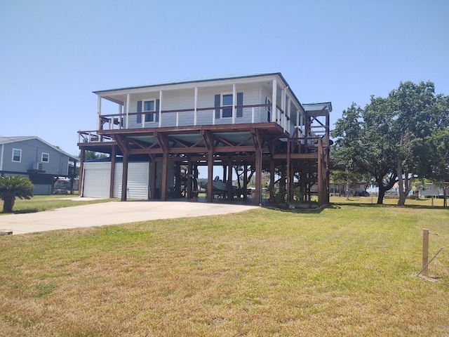 rear view of house featuring a balcony, a garage, and a lawn