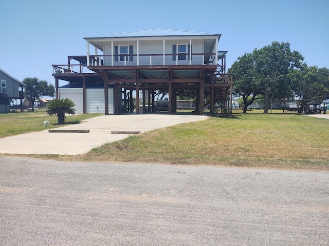 view of front of property with a front yard, a balcony, and a garage