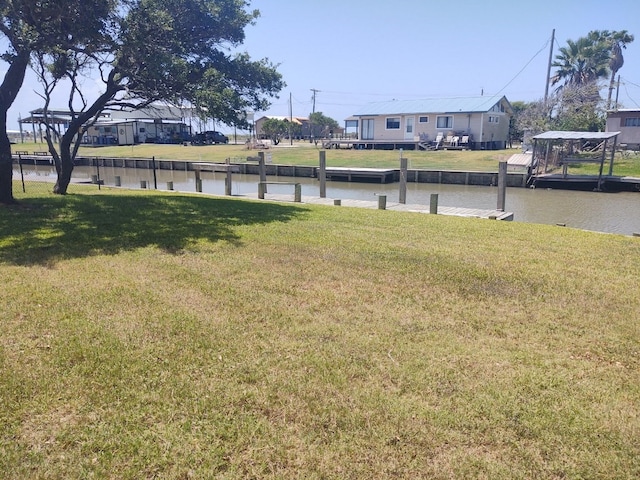 exterior space featuring a boat dock and a water view