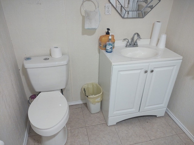 bathroom featuring tile flooring, toilet, and vanity