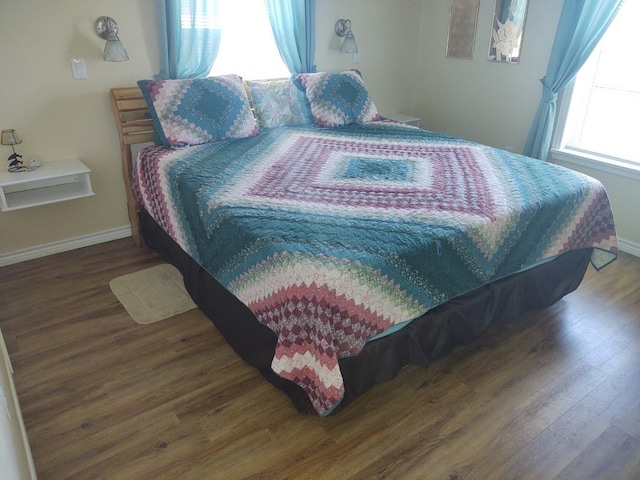 bedroom with dark hardwood / wood-style flooring