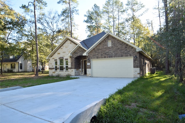 view of front of home featuring a front yard and a garage