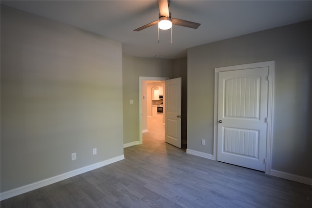 unfurnished bedroom featuring ceiling fan and light hardwood / wood-style floors