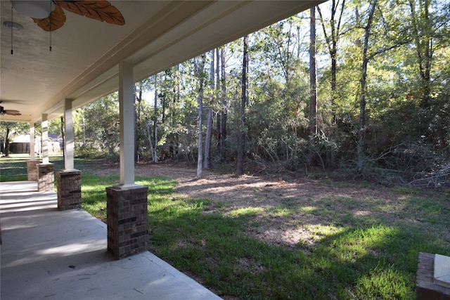 view of yard with ceiling fan