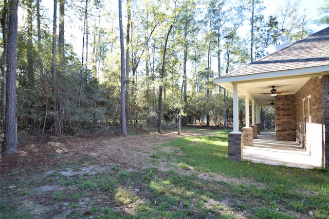 view of yard with ceiling fan