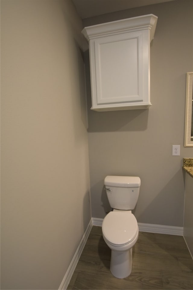 bathroom featuring vanity, hardwood / wood-style floors, and toilet