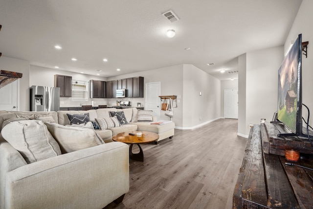 living room with light hardwood / wood-style flooring