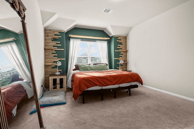 bedroom featuring lofted ceiling, carpet, and brick wall