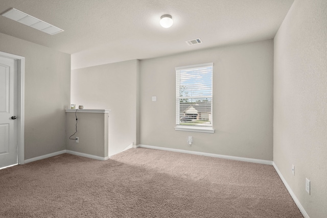 spare room featuring light colored carpet