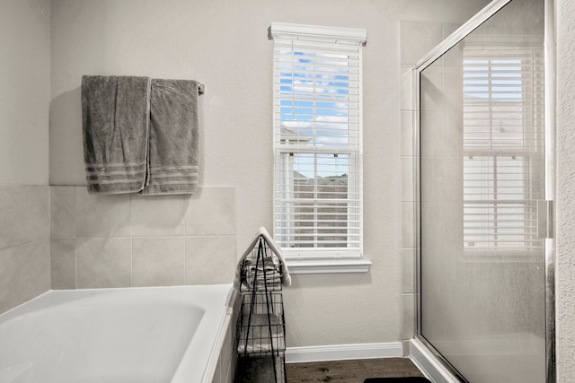 bathroom with hardwood / wood-style floors and plus walk in shower