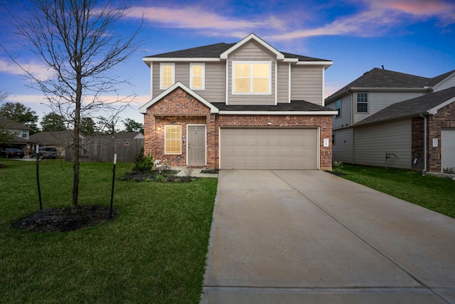 view of front of house with a yard and a garage