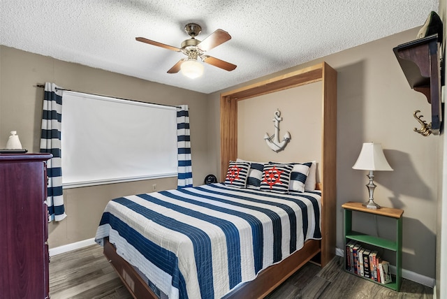 bedroom with dark hardwood / wood-style flooring, a textured ceiling, and ceiling fan