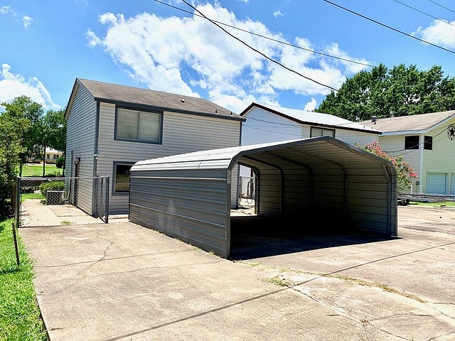 view of side of property with a carport