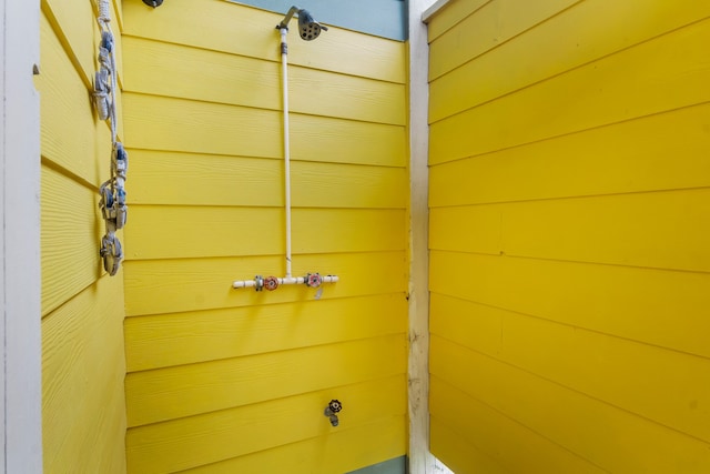 bathroom with wood walls