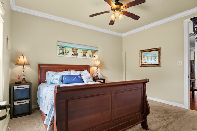 carpeted bedroom featuring ornamental molding and ceiling fan