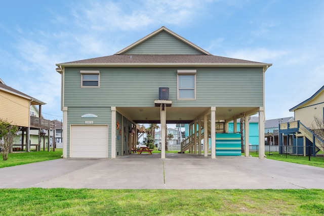 view of front of house with a front yard and a garage