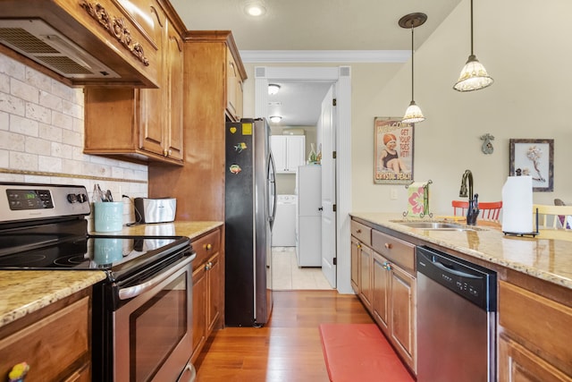 kitchen with decorative light fixtures, light hardwood / wood-style floors, custom range hood, stainless steel appliances, and light stone countertops