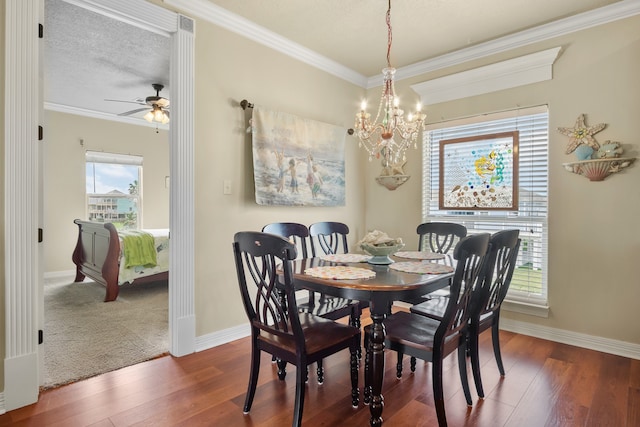 carpeted dining space featuring a wealth of natural light, ornamental molding, and ceiling fan with notable chandelier