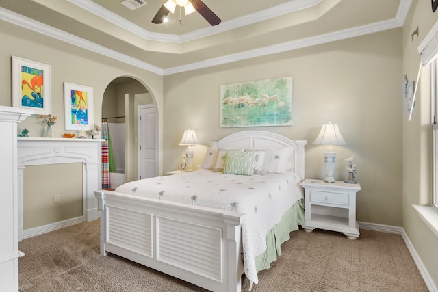 bedroom featuring ceiling fan, a raised ceiling, ornamental molding, and carpet floors