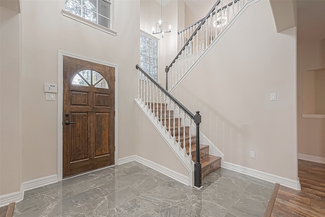 foyer with a towering ceiling and an inviting chandelier