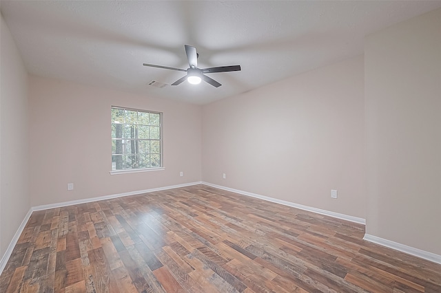 spare room with hardwood / wood-style flooring and ceiling fan