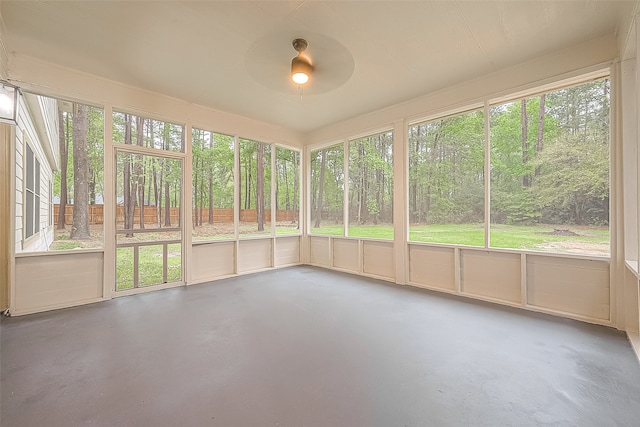 unfurnished sunroom featuring ceiling fan