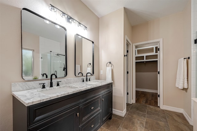 bathroom featuring vanity and a shower with shower door