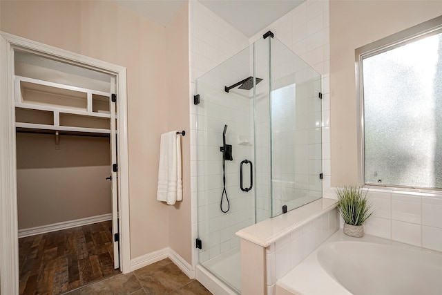 bathroom featuring hardwood / wood-style flooring and plus walk in shower