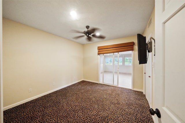 carpeted empty room featuring ceiling fan