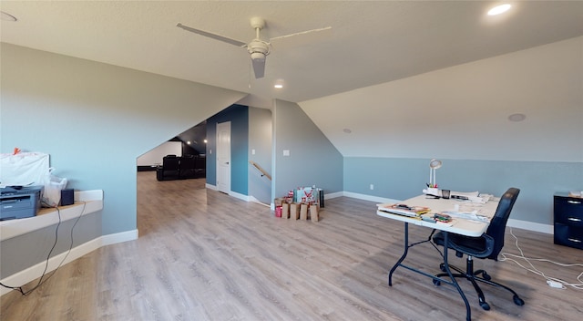 office space with lofted ceiling, ceiling fan, and light hardwood / wood-style flooring