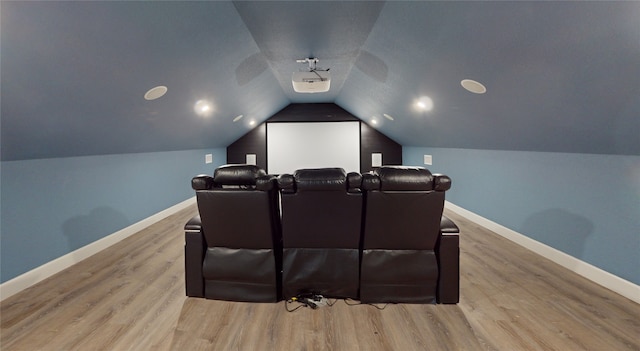 cinema room featuring vaulted ceiling and light wood-type flooring