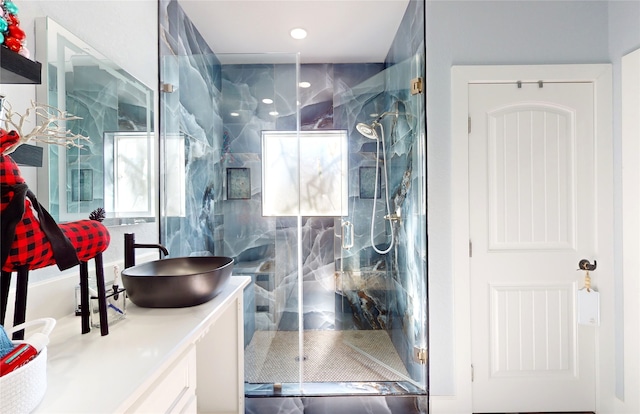 bathroom with walk in shower and vanity