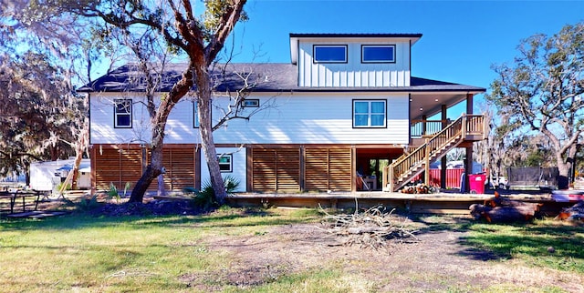 rear view of house with a lawn and a deck