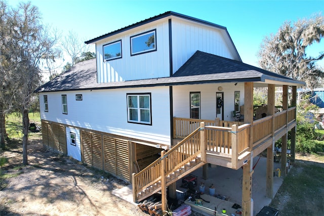 rear view of property with a wooden deck